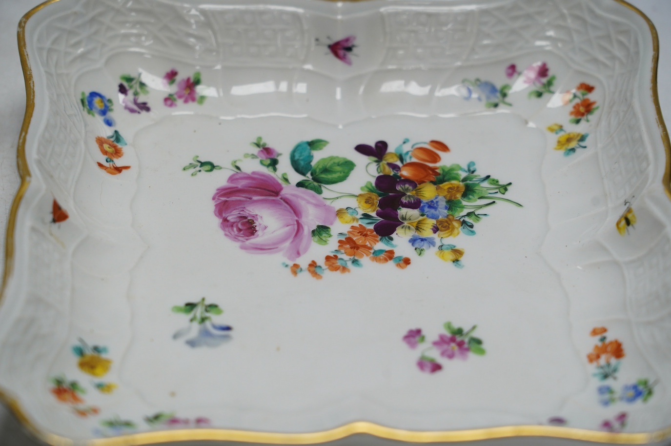 A pair of Meissen square shaped dishes, painted with scattered floral sprigs. Condition - fair to good